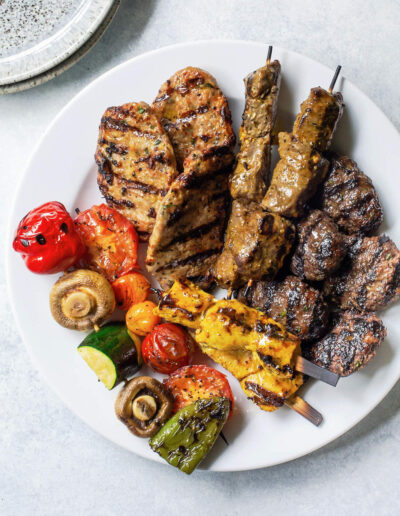 Lamb chicken and beef skewer and kabob platter with mixed vegetables